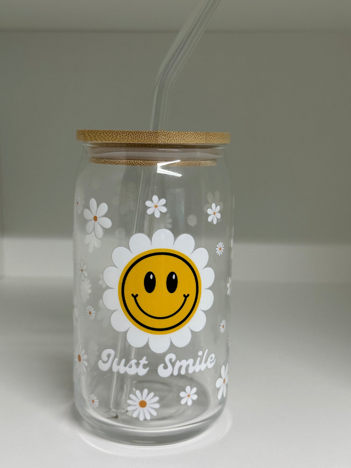 Clear bottle with smiley face design and 'Just Smile' text on a plain background