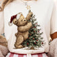 Cream sweatshirt with a teddy bear decorating a Christmas tree design.
