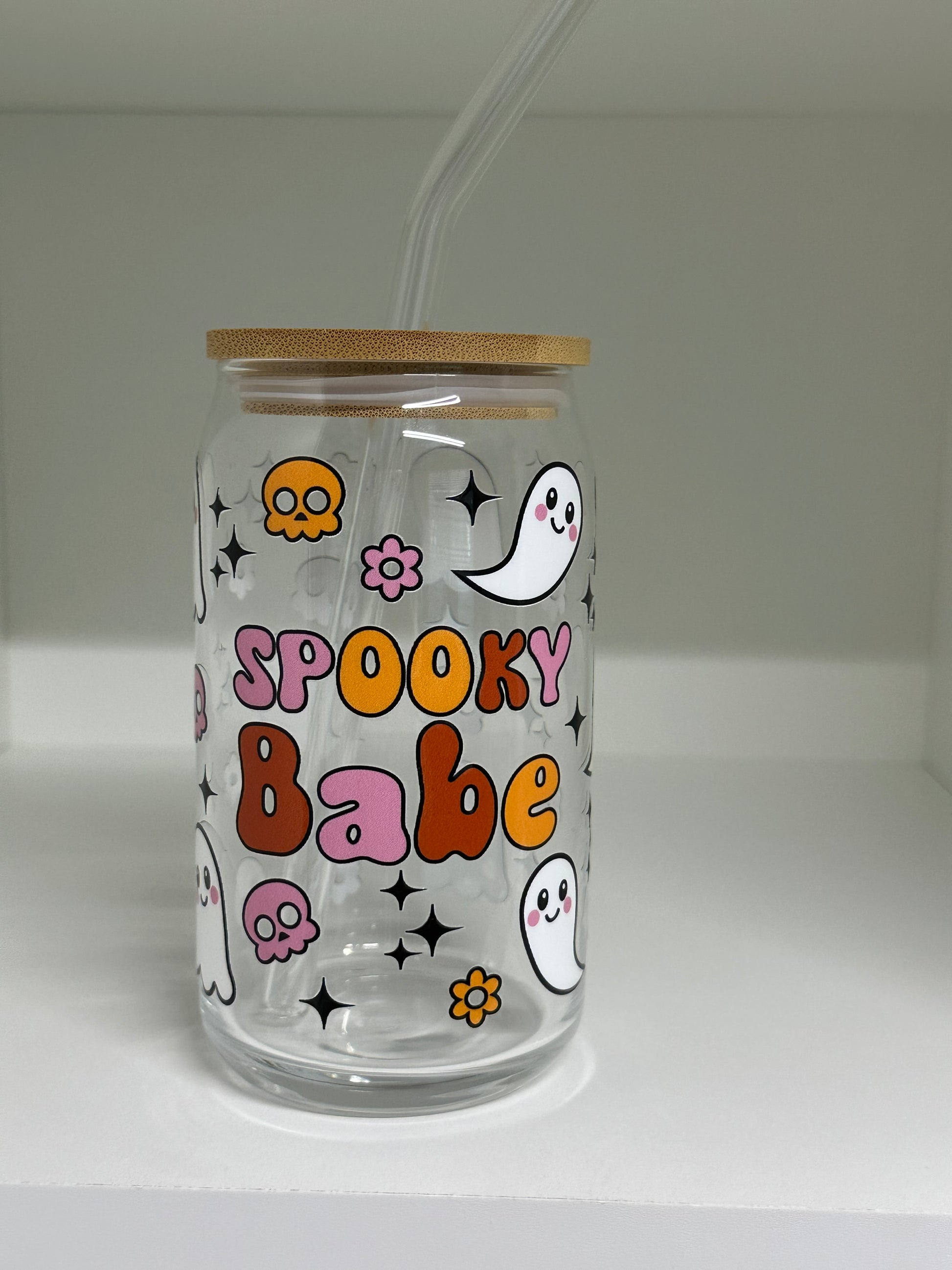 16oz glass cup with ghosts and floral pattern on a clear background
