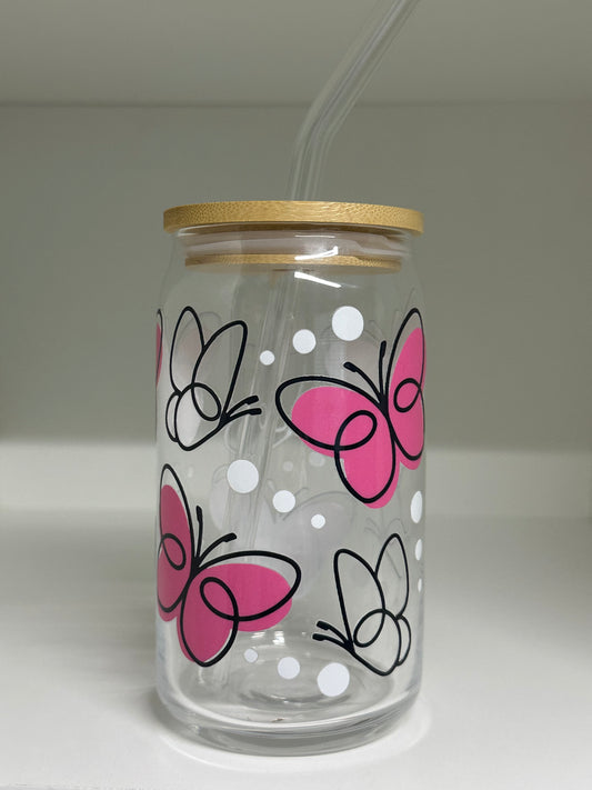Clear tumbler with pink and black butterfly designs on a white background