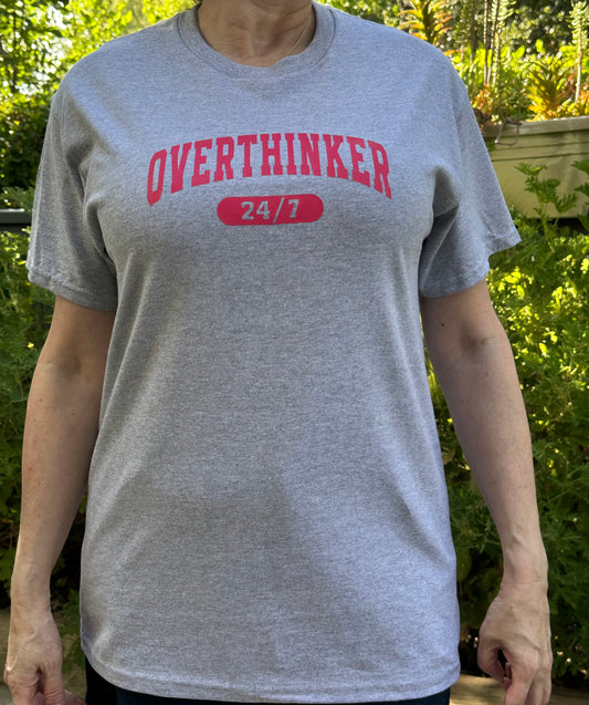 gray t-shirt with 'OVERTHINKER 24/7' text in pink.