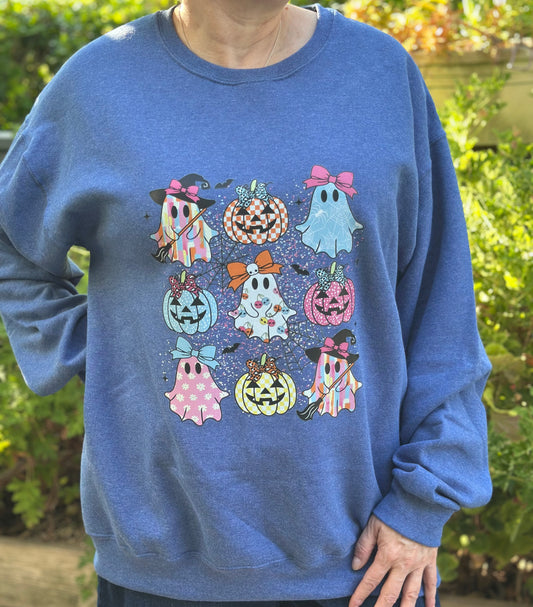 Blue sweatshirt with Halloween-themed graphics in an outdoor setting