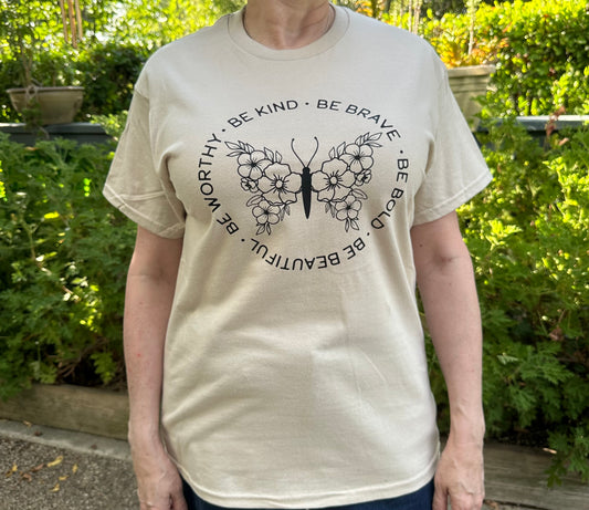 beige t-shirt with a motivational quote and butterfly design.