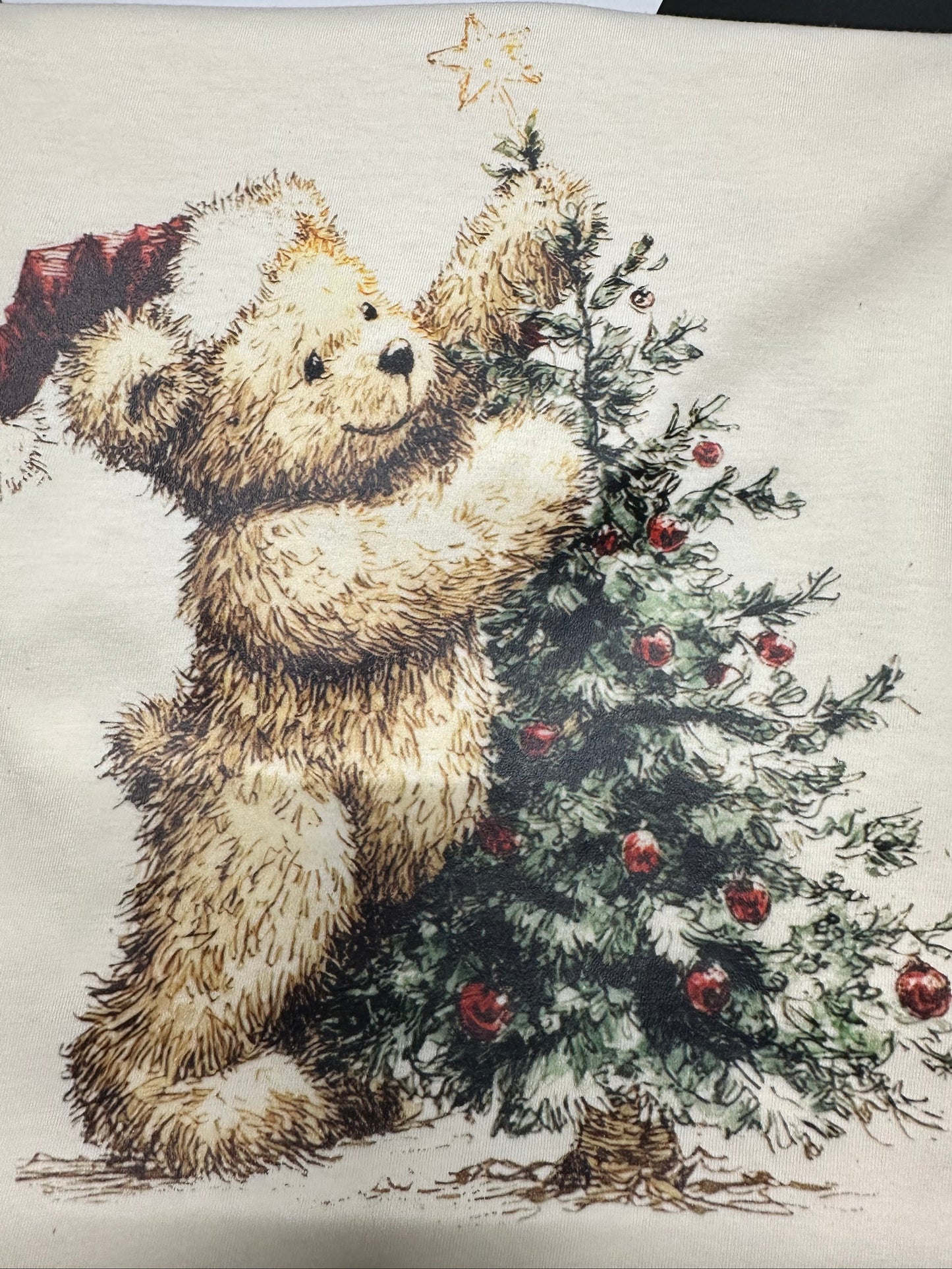 design of a bear and Christmas tree on fabric.