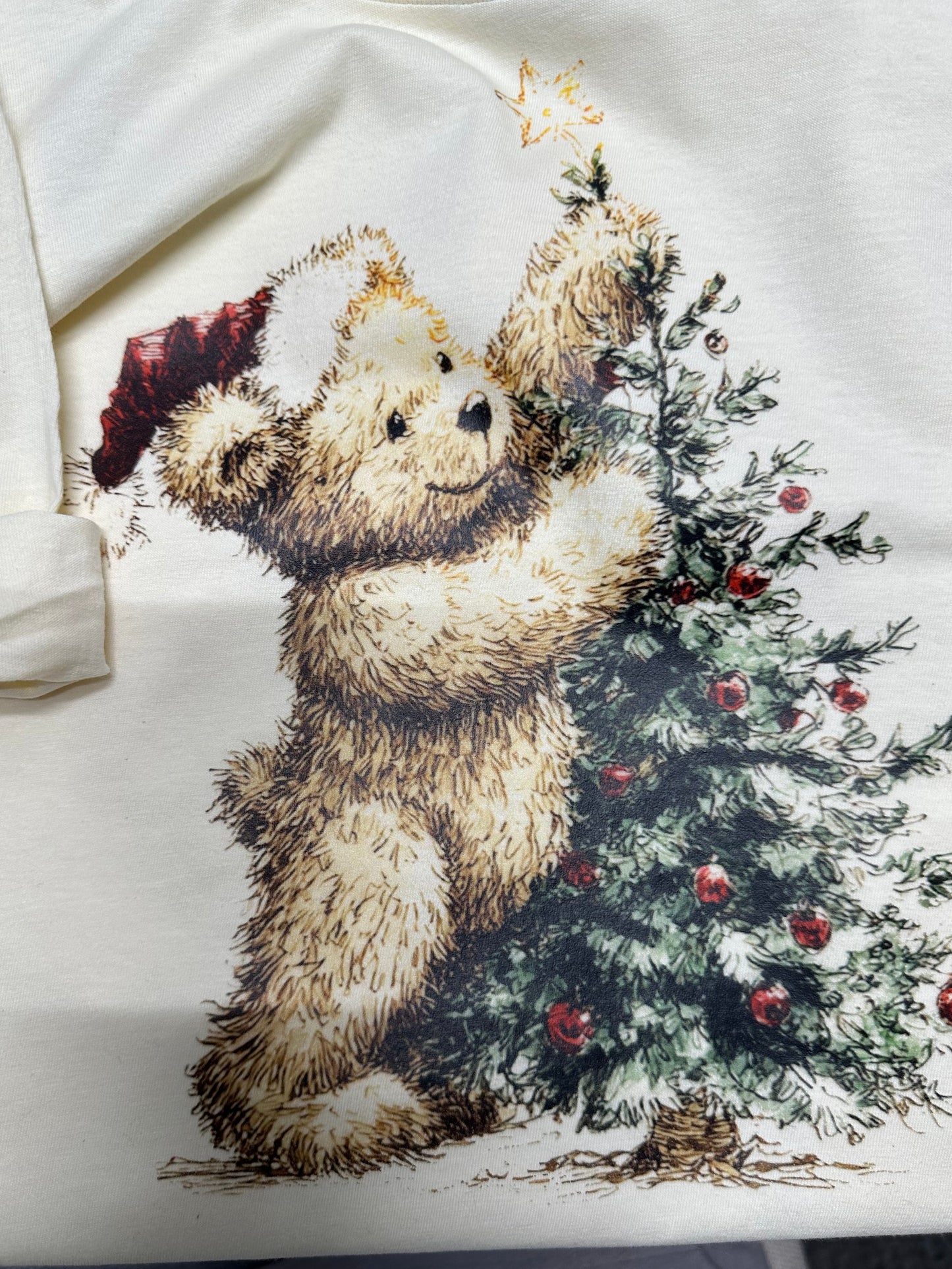 Cream T shirt with a bear and floral design on a white background