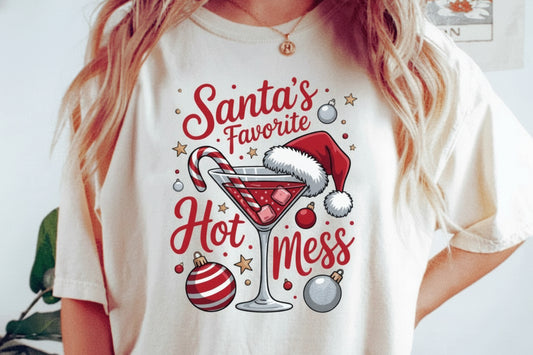 White t-shirt with Christmas-themed design featuring a cocktail and text, worn by a person.